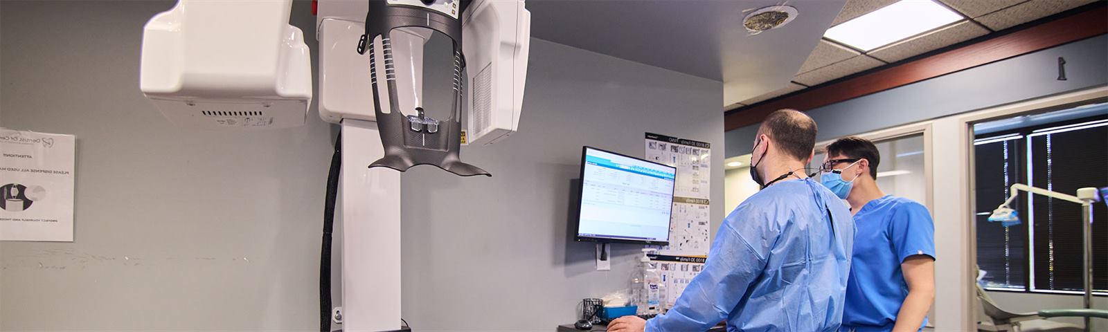 Dentist reviewing digital X-rays with a patient